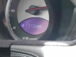 Driving fast. 150mph, and showing off her body